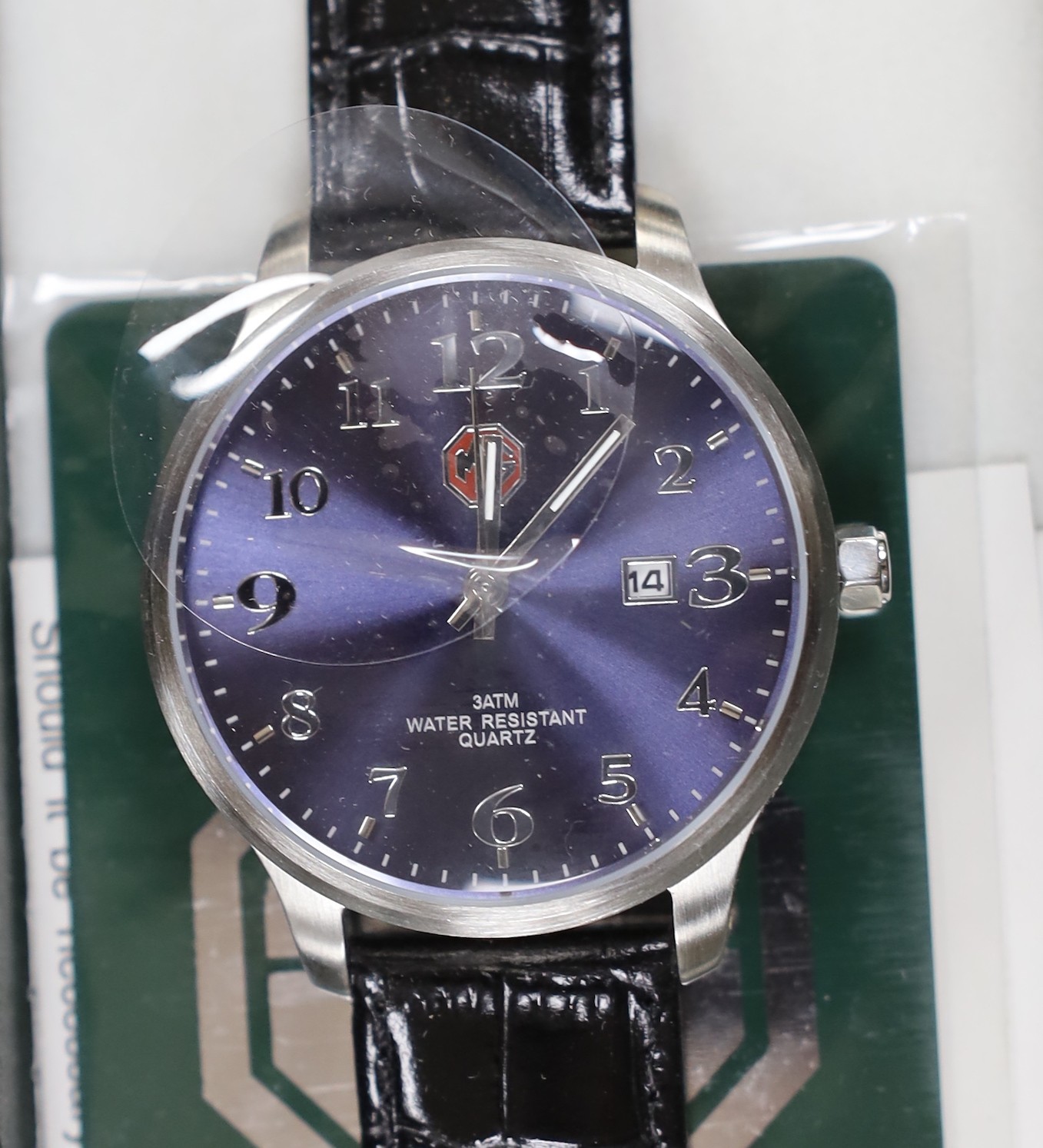 A gentleman's modern stainless steel Delorean automatic calendar wrist watch, with red face and three subsidiary dials, together with three assorted modern MG motors quartz wrist watches.